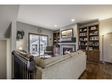 Living room features built-in bookcases with gas f