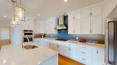 KITCHEN WITH QUARTZ COUNTERTOPS AND ISLAND