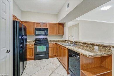 Great kitchen with black appliances, lots of wood 