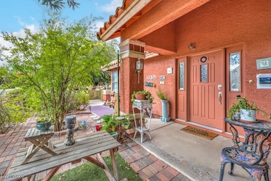 Property entrance with a patio and stucco siding