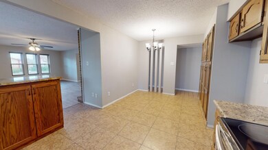 Dining space featuring ceiling fan with notable ch