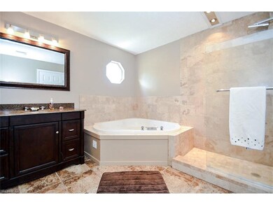 Four piece bathroom with tub and walk in shower.