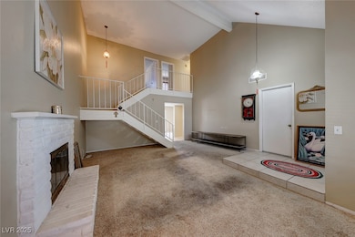 Carpeted entrance foyer featuring beam ceiling, a