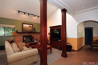 Living room with fireplace and hallway to bedrooms