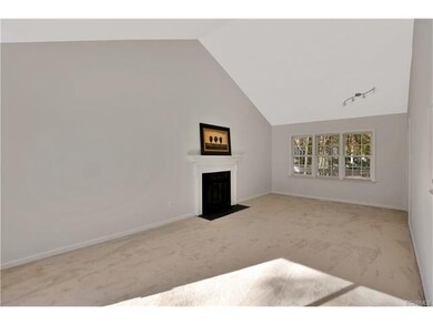 Huge great room with new carpet, cathedral ceiling