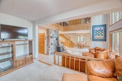 Carpeted living room with a chandelier