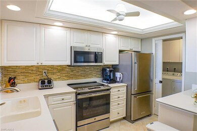 Kitchen with stainless steel appliances, sink, lig