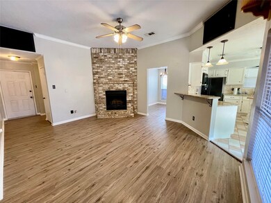 Living Room features a wood burning fire place and is open to Kitchen and Dining Room.  Living Room measures 16' 3