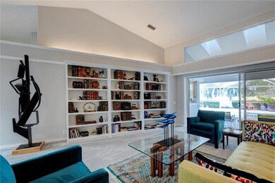 Formal Living Room with sliders overlooking swimming pool.