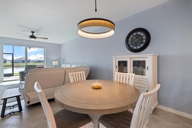 Dining area featuring a water view, light tile pat