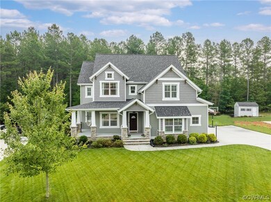 This home has been lovingly elevated from builder-grade with the addition of gorgeous architectural details that give it a true modern-farmhouse style.  Note the Craftsman touches on the exterior, including stone, shaker siding and corbels.