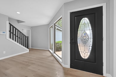Welcoming front entry with large picture windows a