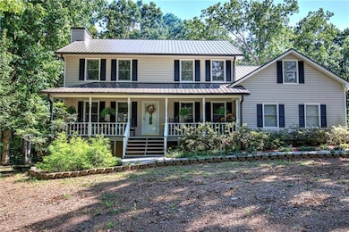 View of front of home with a porch and a chimney