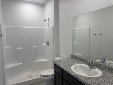 Full bathroom featuring vanity, toilet, and a show