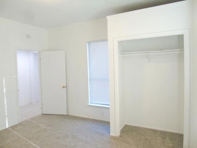 Unfurnished bedroom with a closet and carpet floo