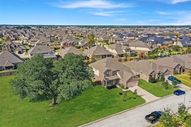 Aerial view of home show casing the open green space next to the house.
