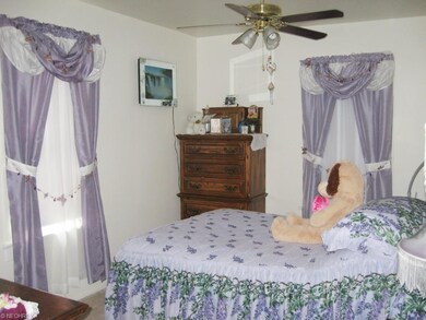 Master Bedroom has two windows and neutral colors.
