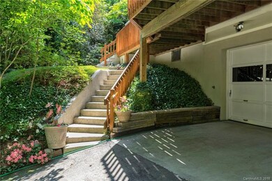Manicured landscaping bordering stairs to the fron