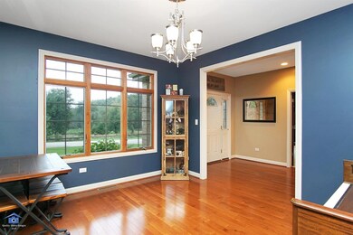 Dining room off of front entry with hard wood floors, upgraded Anderson windows w/ transoms throughout home