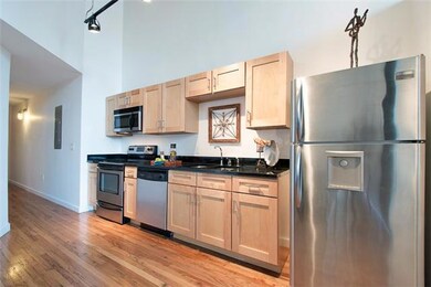 Sleek and stylish kitchen is open to the informal dining area featuring granite countertops, natural maple cabinetry, and stainless steel appliances 