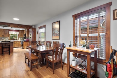 Dining room featuring light wood-style flooring and recessed lighting.