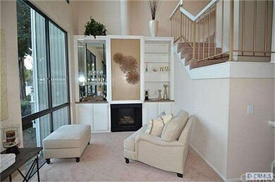 Sitting area off living room features fireplace