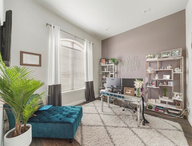 Quietly nestled in front of the home is the handsome home office! Featuring high ceilings, large window with privacy blinds, and custom paint!