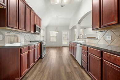 Oversized eat in kitchen with view of the backyard.