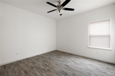 Unfurnished room with wood finished floors and ceiling fan