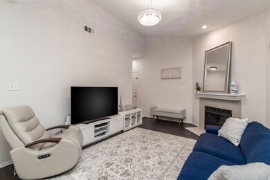 Living room with a tile fireplace and hardwood / w