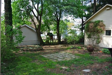 Backyard with patio area and raised garden bed.  P