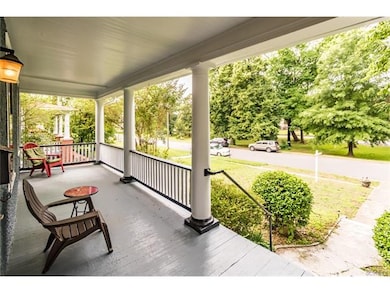 Incredible front porch overlooking gorgeous tree-lined streetscape and median green space!