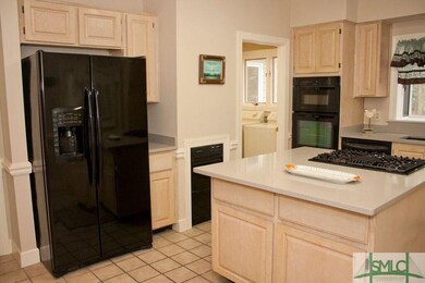 KITCHEN FACING LAUNDRY ROOM AND HALLWAY TO LEFT