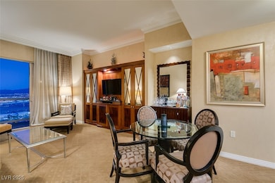 Dining area with ornamental molding and baseboards