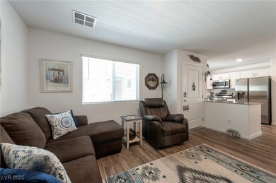Living room featuring wood finished floors, basebo
