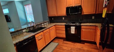 Kitchen open to living room with gas stove