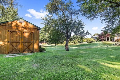 A shed sits at the back of the yard for storage of