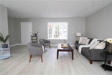 Living room with light hardwood / wood-style floor