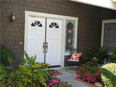 Double door entry, fountain & beautiful azaleas.