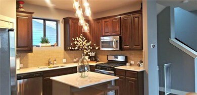 Kitchen featuring appliances with stainless steel