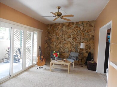 Family room has thermal paned sliding doors that lead to screened area. Neutral colors and nice carpet.
