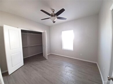 Unfurnished bedroom featuring light wood finished floors, a ceiling fan, and a closet