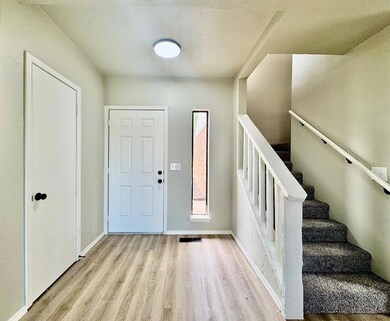 Entrance foyer with wood finished floors and baseb