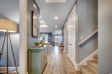 Hallway with light hardwood / wood-style flooring