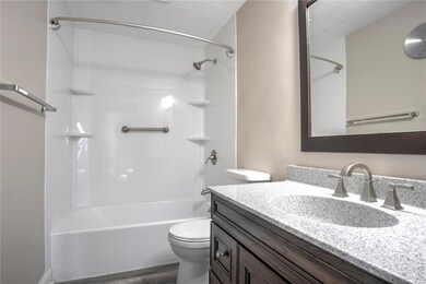 Lovely full bath with solid surface counter.