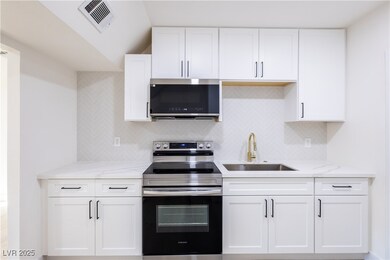 Kitchen with stainless steel appliances, a sink, w