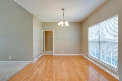 Dining room features hardwood floors and lots of light from the large windows.