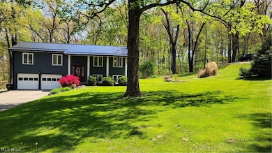Bi-level home featuring a front lawn and a garage