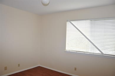 Unfurnished room featuring dark wood-style floors
