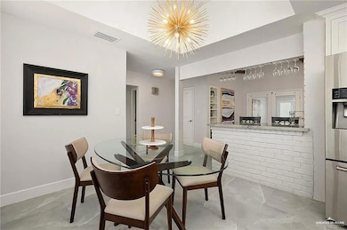 Dining space featuring a chandelier and built in shelves